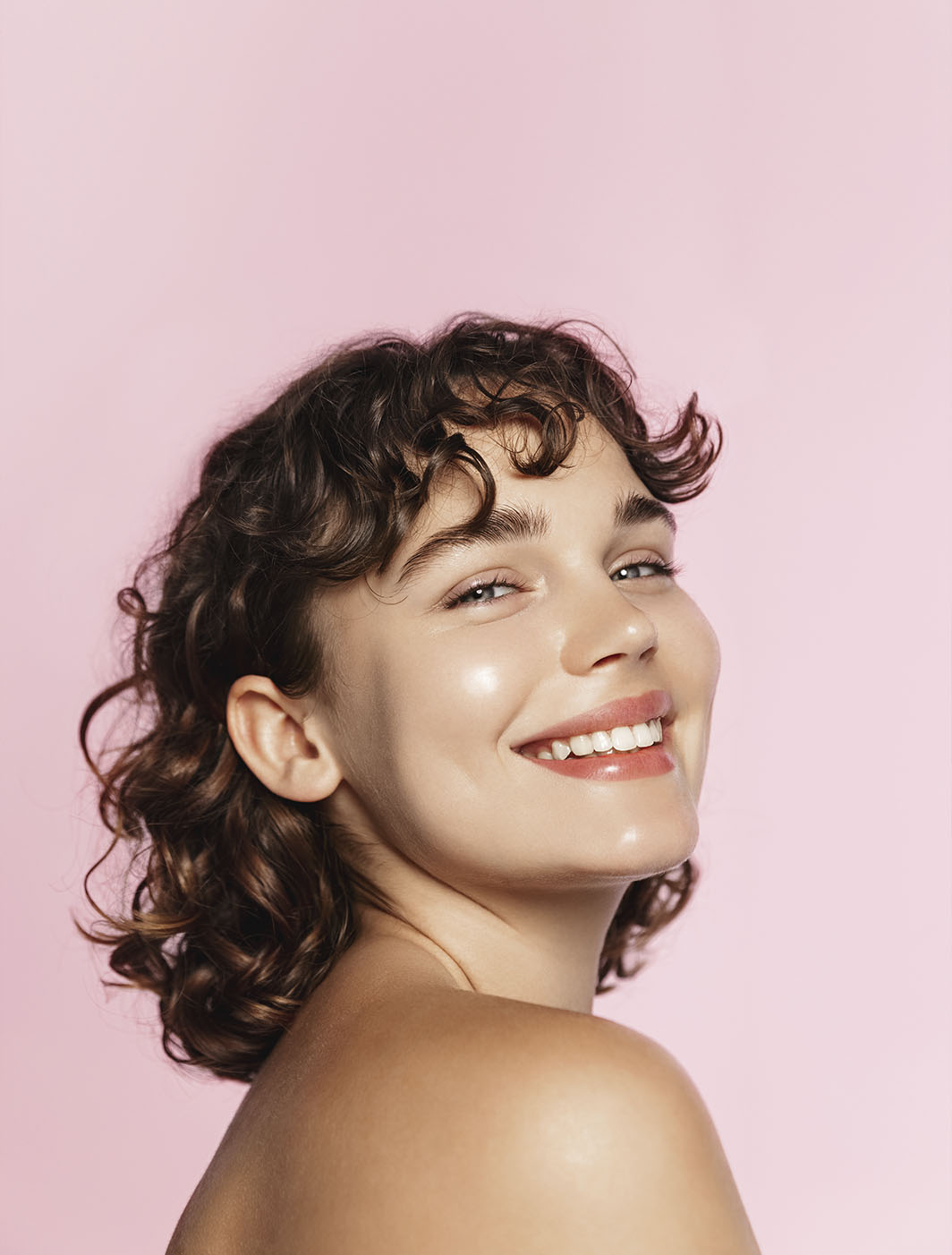 beautiful young woman with pink earrings