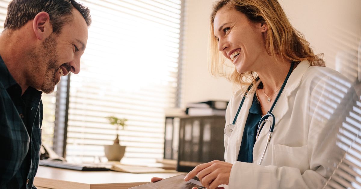 Blog-Totality Medispa-How Privacy and Personalization Elevate the Medspa Experience Doctor smiling while discussing a personalized treatment plan with a patient during a private consultation.